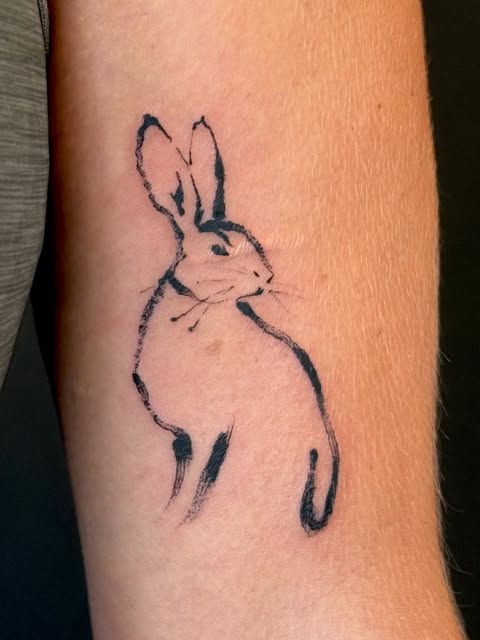 Hare tattoo on thigh