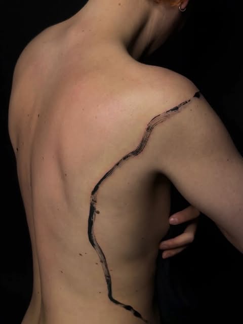One line tattoo on spine